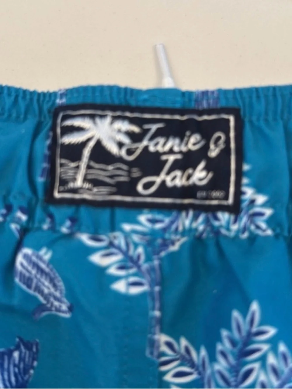 Janie and Jack Teal World Love Swim Trunks with Animal Print